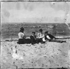 Two couples sitting on the beach